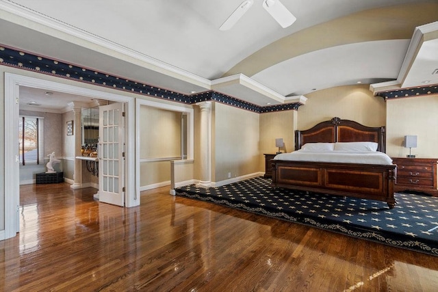 bedroom with ceiling fan, decorative columns, hardwood / wood-style floors, lofted ceiling, and ornamental molding