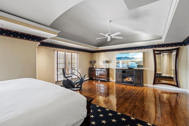 bedroom with a tray ceiling, ceiling fan, lofted ceiling, and hardwood / wood-style flooring