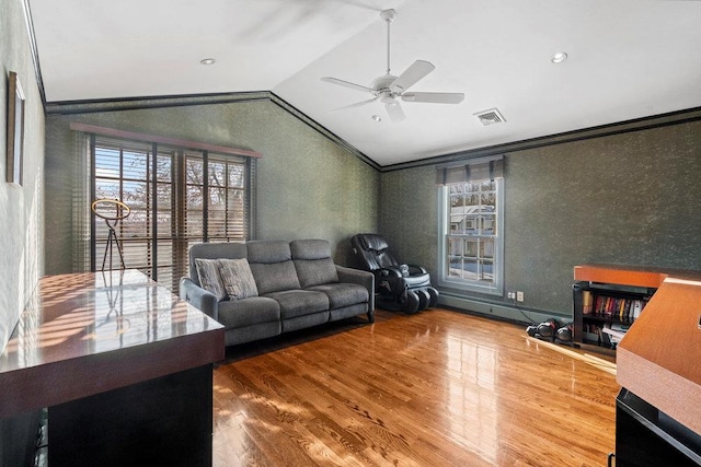 living room featuring a wealth of natural light, hardwood / wood-style floors, ceiling fan, and lofted ceiling