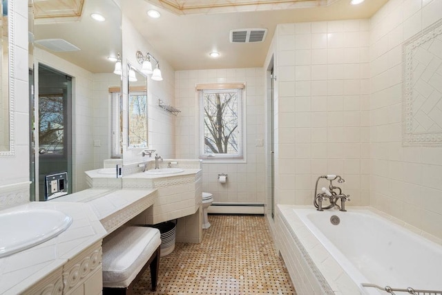 bathroom with vanity, a baseboard radiator, tile walls, and toilet