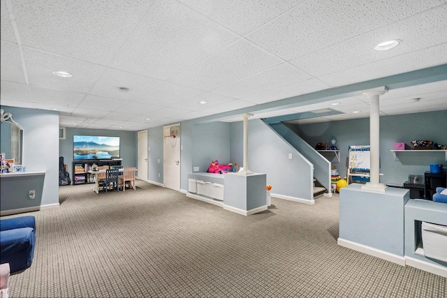 playroom with carpet flooring and a drop ceiling