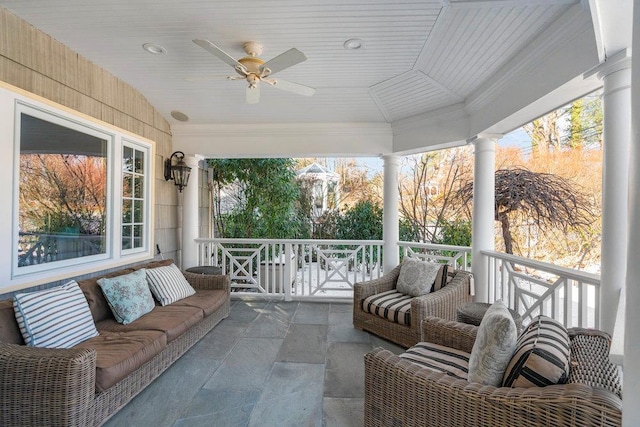 sunroom with vaulted ceiling, ceiling fan, a healthy amount of sunlight, and wood ceiling