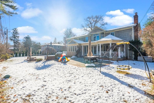 snow covered property with a patio area