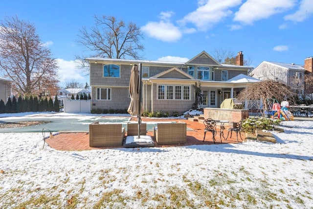 snow covered back of property featuring french doors