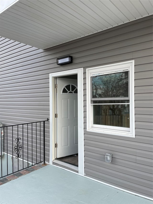 view of exterior entry with a balcony