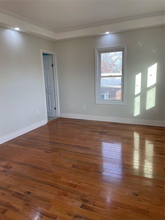 spare room with dark hardwood / wood-style flooring and ornamental molding