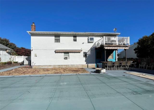 back of property featuring a patio and exterior bar