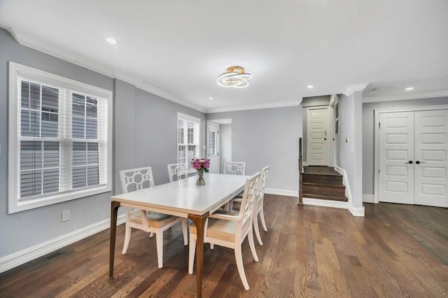 dining room with dark hardwood / wood-style floors and ornamental molding