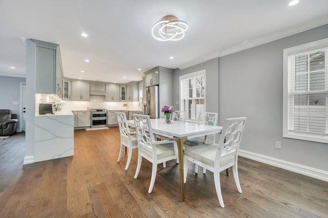 dining room with dark hardwood / wood-style flooring and ornamental molding