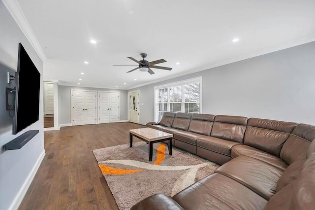 living room with ceiling fan, dark hardwood / wood-style flooring, and ornamental molding