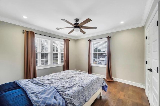 bedroom featuring ceiling fan, crown molding, and dark wood-type flooring