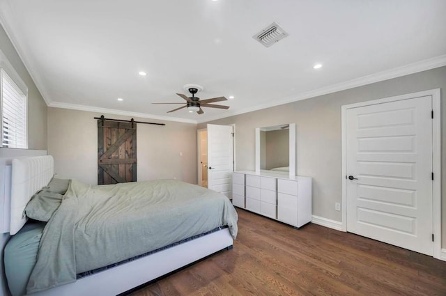 bedroom with ceiling fan, a barn door, dark hardwood / wood-style flooring, and crown molding