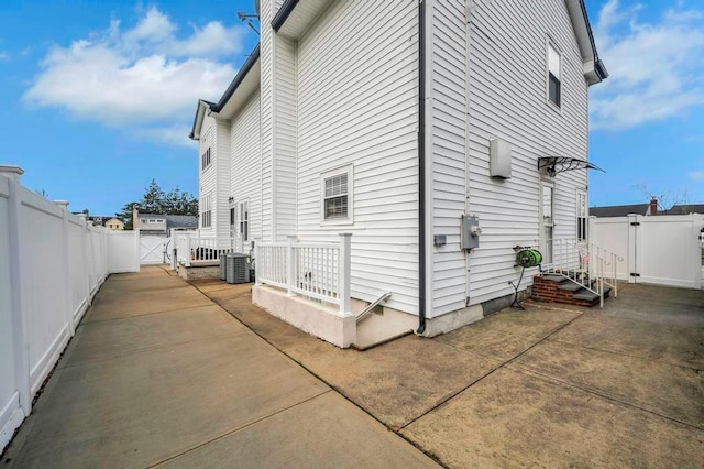 view of side of home featuring central AC unit