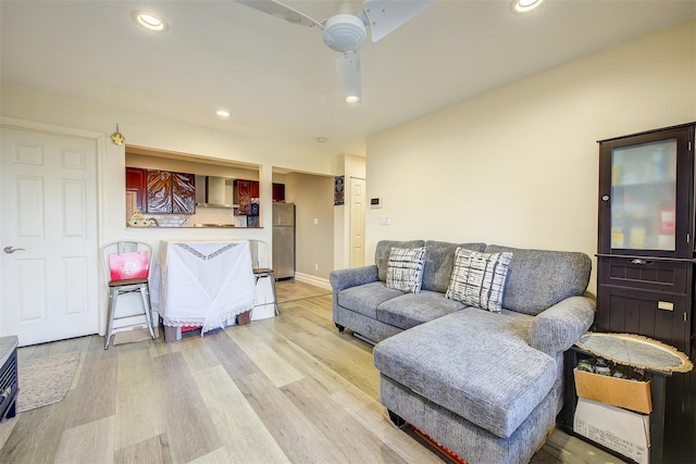 living room with ceiling fan and light wood-type flooring