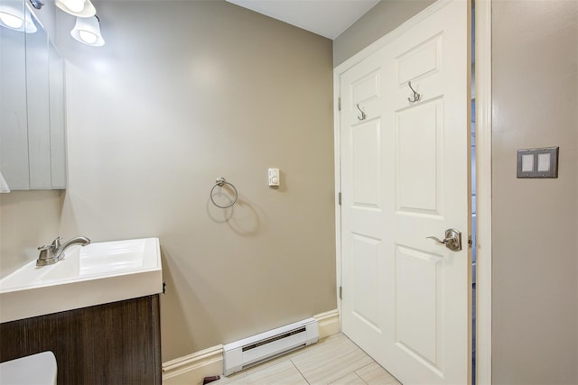 bathroom with baseboard heating and vanity