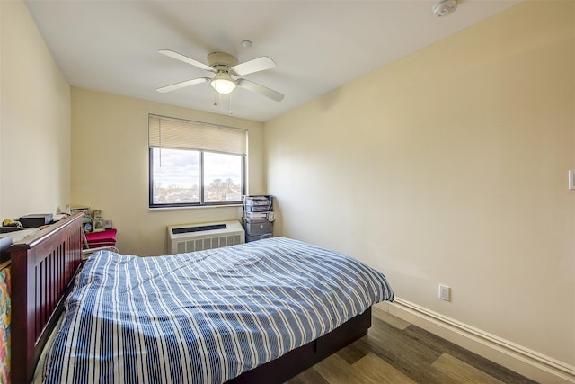 bedroom with a wall unit AC, ceiling fan, and hardwood / wood-style floors