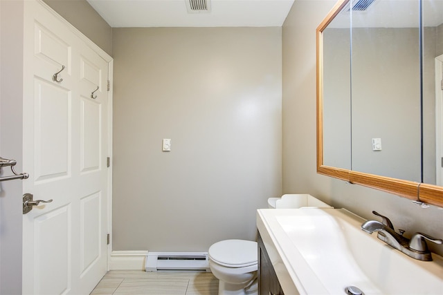 bathroom with toilet, baseboard heating, and sink