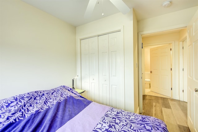 bedroom featuring ceiling fan, a closet, and light hardwood / wood-style floors