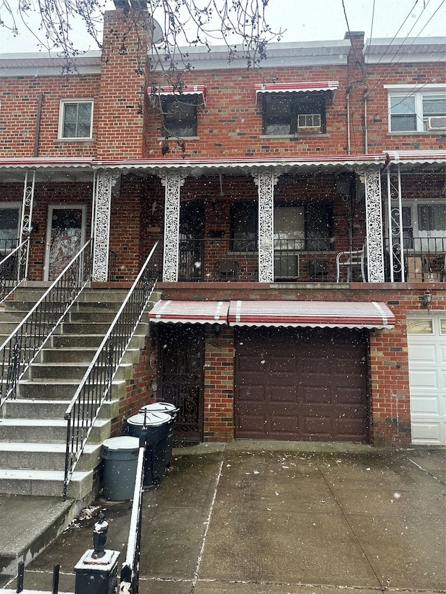 rear view of property with a garage