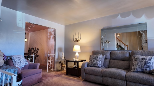 carpeted living room with stairs