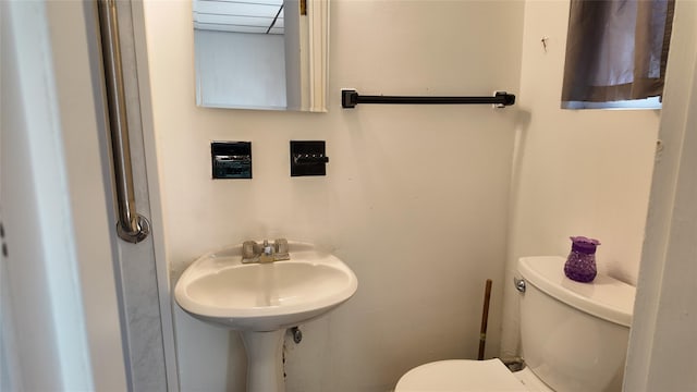 bathroom with toilet and a sink