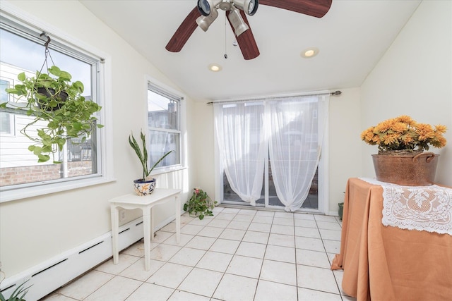 sitting room with ceiling fan, light tile patterned flooring, a baseboard heating unit, and vaulted ceiling