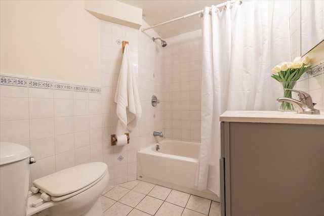 full bathroom with sink, tile patterned flooring, toilet, shower / bath combo with shower curtain, and tile walls