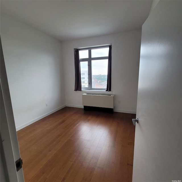 unfurnished room featuring dark hardwood / wood-style floors