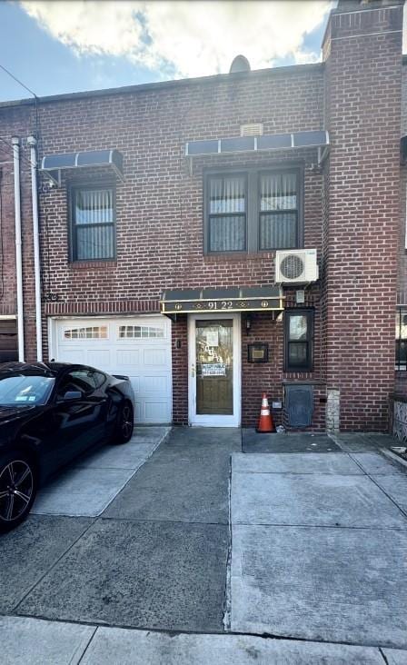 townhome / multi-family property with ac unit and a garage