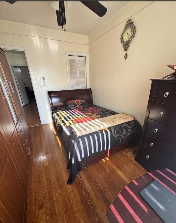 bedroom featuring ceiling fan and dark wood-type flooring