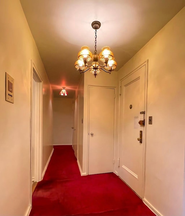 hallway with an inviting chandelier