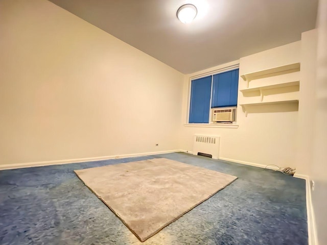 unfurnished room featuring radiator and lofted ceiling