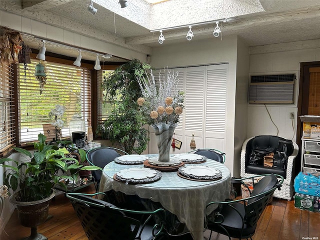 dining area with hardwood / wood-style floors and a wall mounted AC