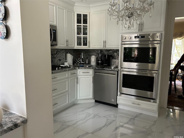 kitchen featuring white cabinets, backsplash, sink, and stainless steel appliances