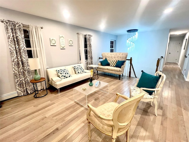 living room with a chandelier and wood-type flooring