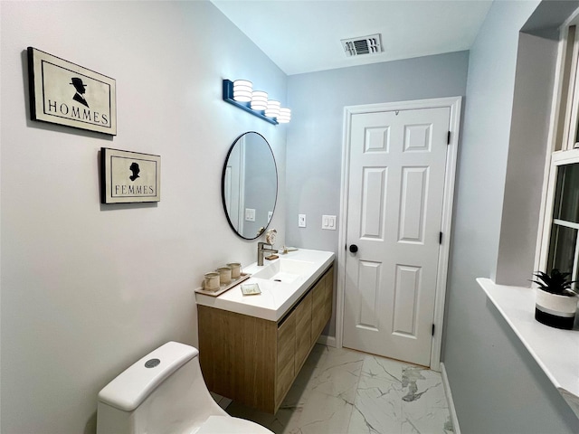 bathroom featuring toilet and vanity