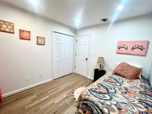 bedroom featuring light hardwood / wood-style flooring and a closet