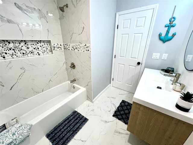 bathroom featuring tiled shower / bath and vanity