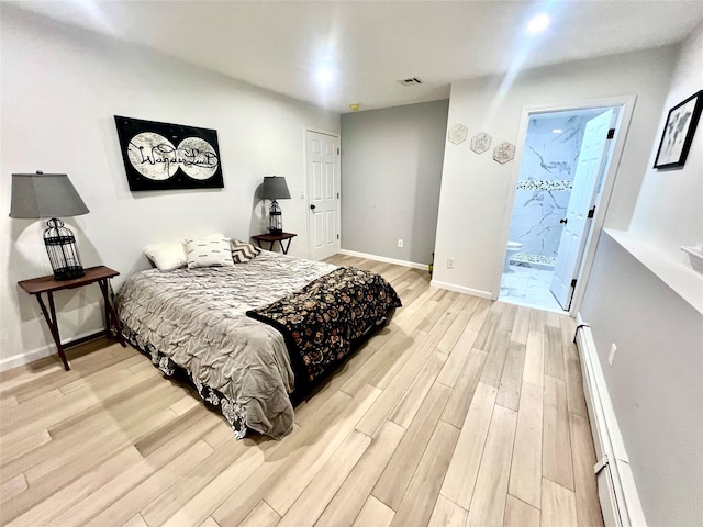 bedroom with a baseboard radiator, connected bathroom, and light hardwood / wood-style flooring