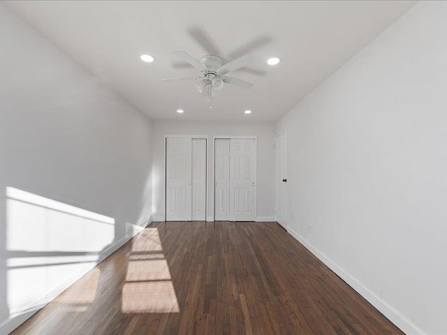 interior space with ceiling fan and dark hardwood / wood-style floors