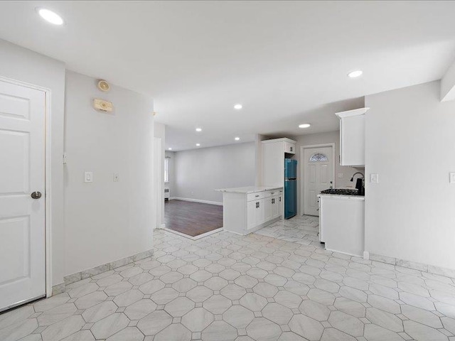 kitchen with white cabinets and fridge