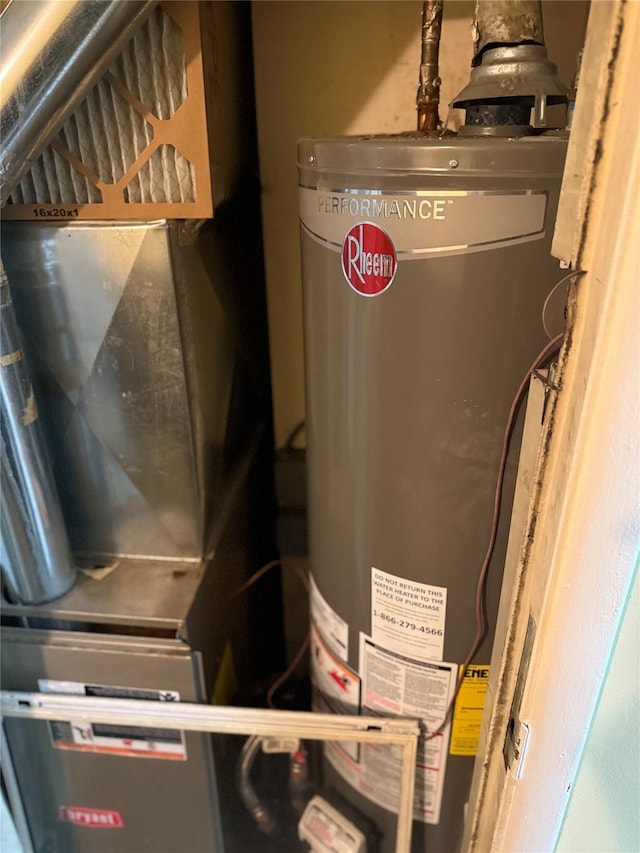 utility room featuring heating unit and water heater