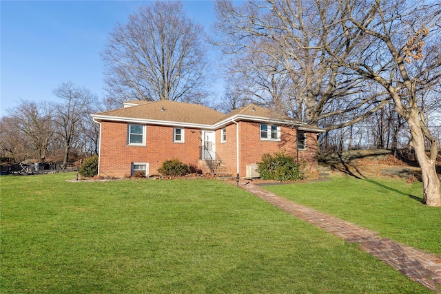 rear view of property featuring a lawn