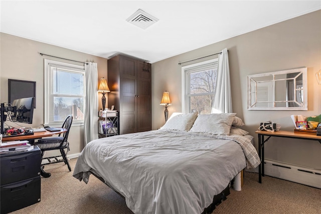 bedroom featuring a baseboard heating unit and light carpet