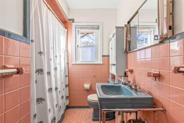 bathroom featuring sink, tile walls, a wealth of natural light, and curtained shower