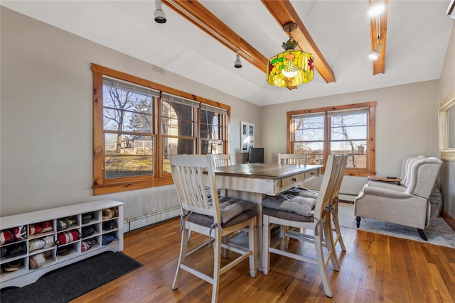 dining area with wood-type flooring, a baseboard heating unit, and beamed ceiling