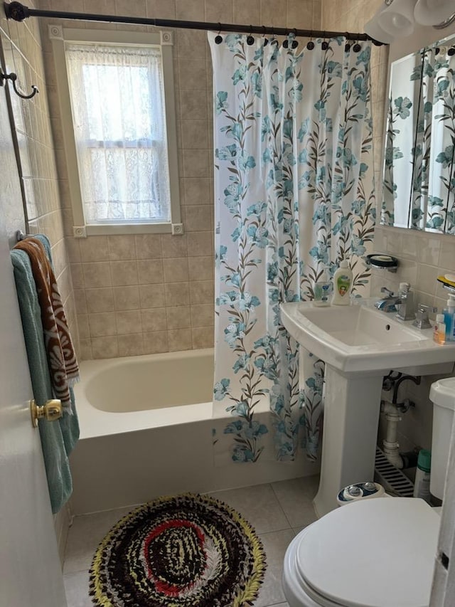 bathroom with shower / tub combo with curtain, toilet, tile walls, tile patterned flooring, and decorative backsplash