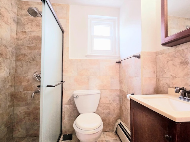 bathroom with vanity, toilet, baseboard heating, tile walls, and a shower with shower door