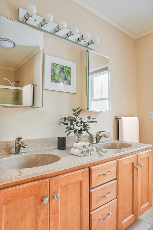 full bath with double vanity, ornamental molding, a sink, and a shower with shower door