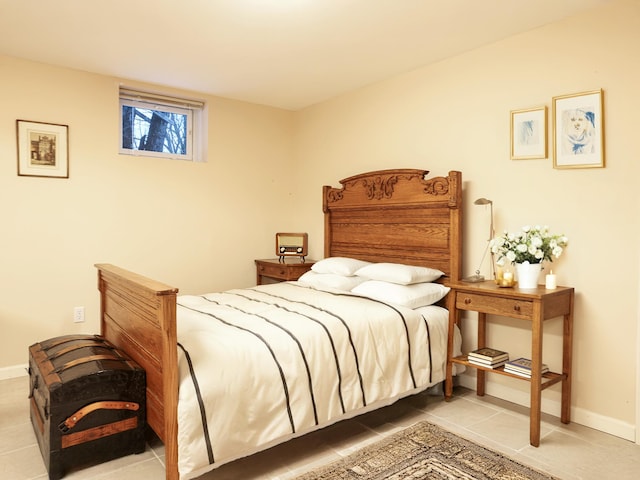 bedroom featuring baseboards and tile patterned floors